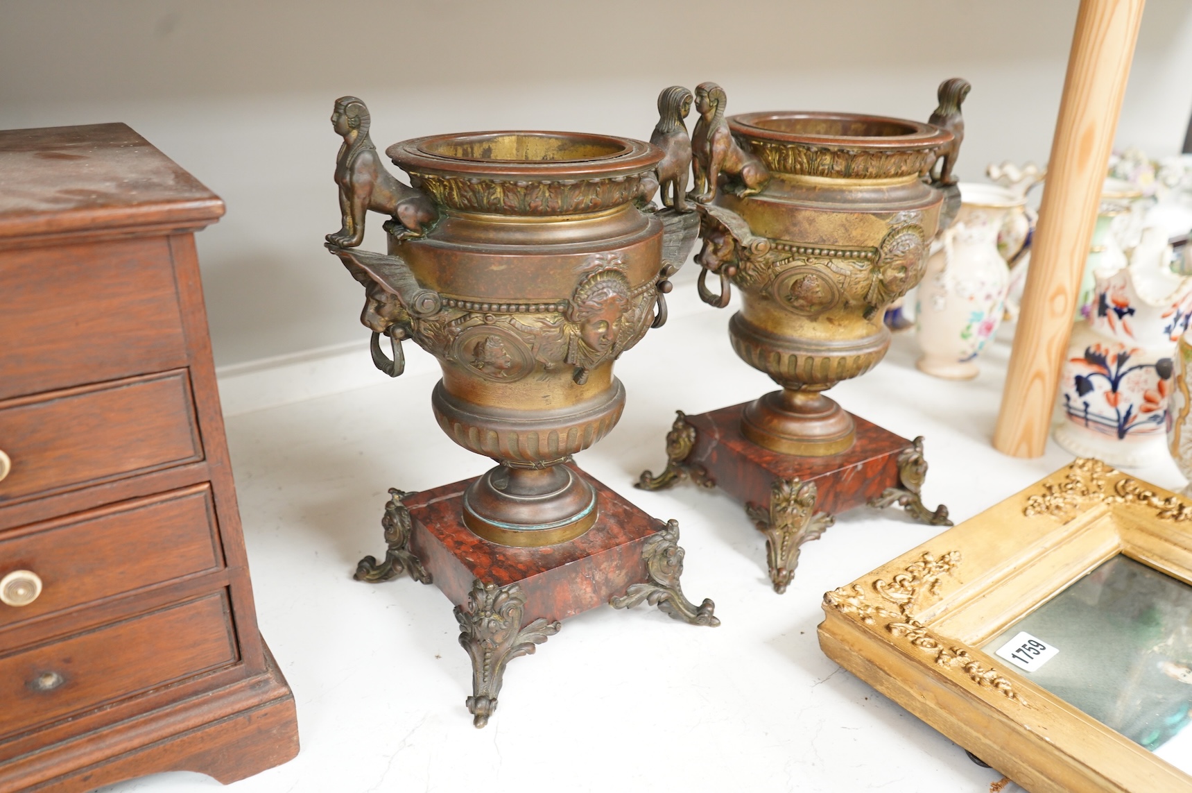 A pair of late 19 century French Egyptian revival bronze and rouge marble urns, 31cm high